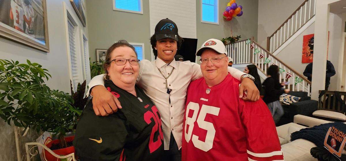 Jalen Coker posing with Linda Oakes (left) and Eric Oakes (right) at Coker’s draft party in April 2024. Jalen and the Oakes’s son, Adam, grew up together.