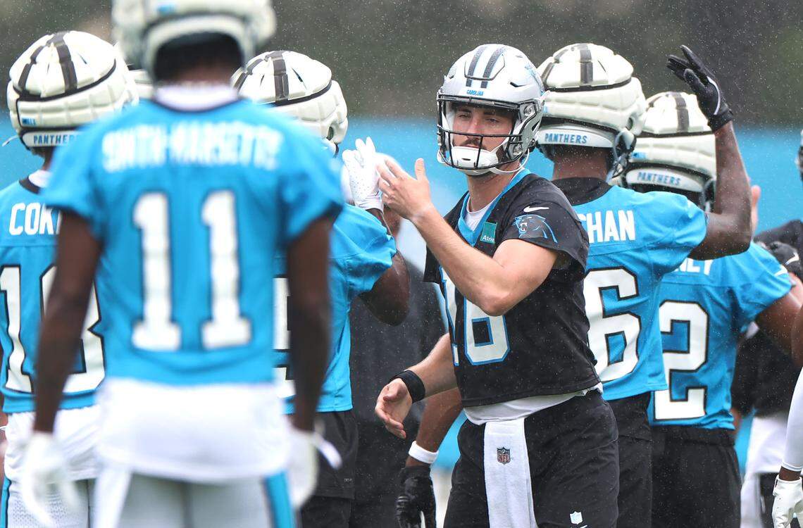 Carolina Panthers quarterback Jack Plummer, center, slaps hands with his teammates prior to a new set of drills on Thursday, July 25, 2024.