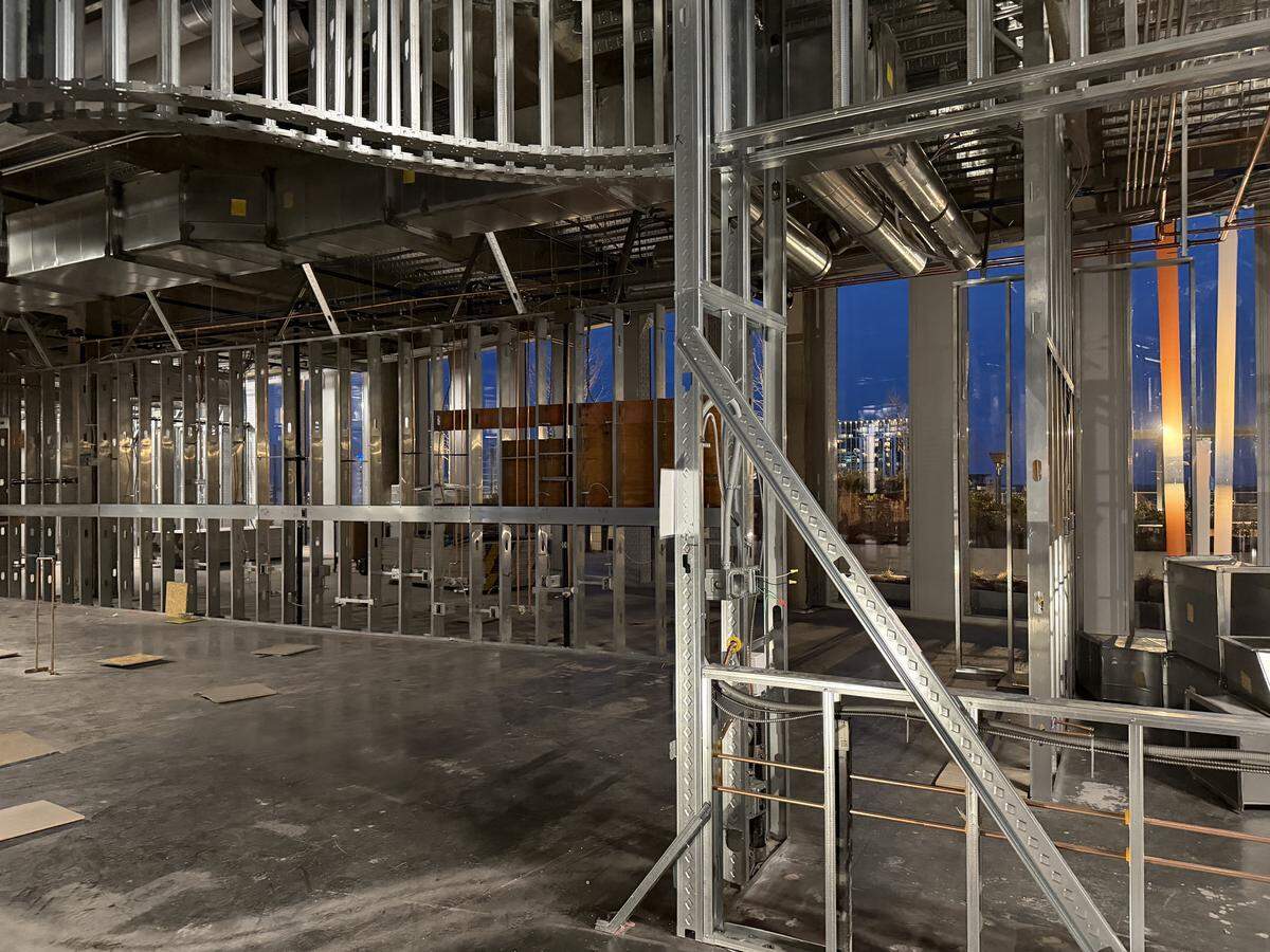 This image shows the interior of a commercial building currently under construction, likely the future site of a restaurant or retail space.
