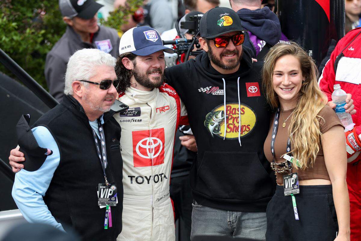 NASCAR Xfinity Series driver Ryan Truex (second from left) celebrates in victory lane with his girlfriend Leah Schwandt (right) and brother NASCAR Cup Series driver Martin Truex Jr (second from right) and his father Martin Truex Sr (left) after winning Saturday’s A-GAME 200 at Dover Motor Speedway. Matthew OHaren-USA TODAY Sports