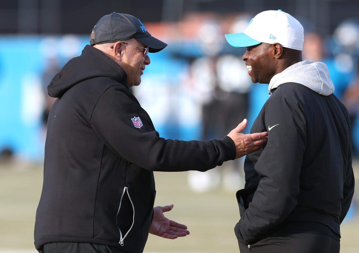 Carolina Panthers team owner David Tepper, left, speaks with defensive coordinator Ejiro Evero during practice on Jan. 6, 2026, in Charlotte.