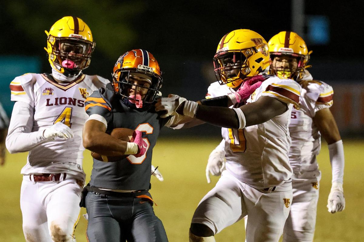 Chambers’ Prince Caldwell (6) stiff arms West Charlotte’s Julian Carmichael (0) during the second quarter at Chambers High School on October 20, 2023.