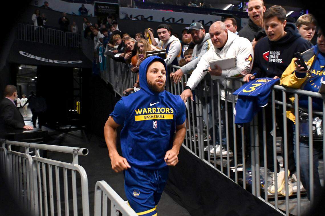 Fans line the visiting team’s tunnel as Golden State Warriors guard Stephen Curry runs onto the court at Spectrum Center in Charlotte, NC on Saturday, October 29, 2022.