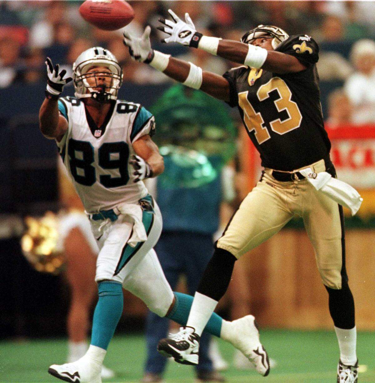 9/12/99 Carollina receiver Rae Carruth (89) barely misses a catch in the end zone as Saint defender Ashley Ambrose (43) knocks the ball away at the last second in the second quarter. The Panthers settled for a field goal on the drive.