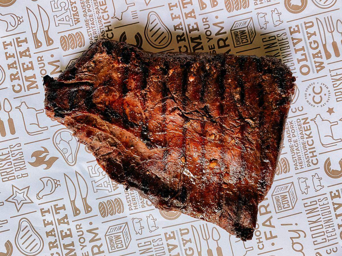 The sample dinner menu at The Finicky Table includes an ornate charcuterie board, followed by grilled steak with roasted green beans and sweet potato hand pies, plus a fruit cobbler or tart.