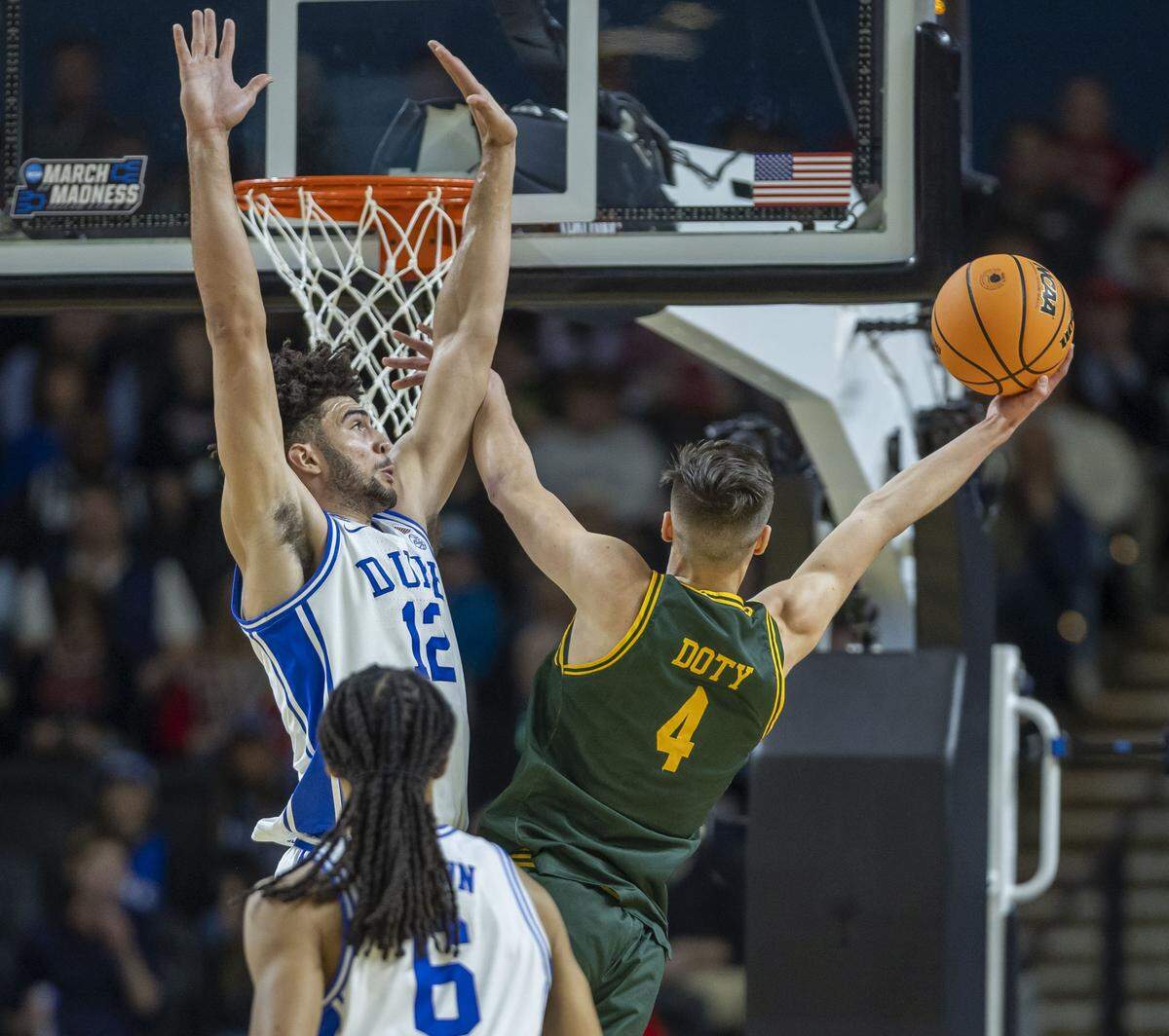 Siena guard Gavin Doty (4) drives to the basket against Duke forward Cameron Boozer (12) in the first half on Thursday, March 18, 2026, during the first round of the NCAA Tournament at Bon Secours Arena in Greenville, S.C.