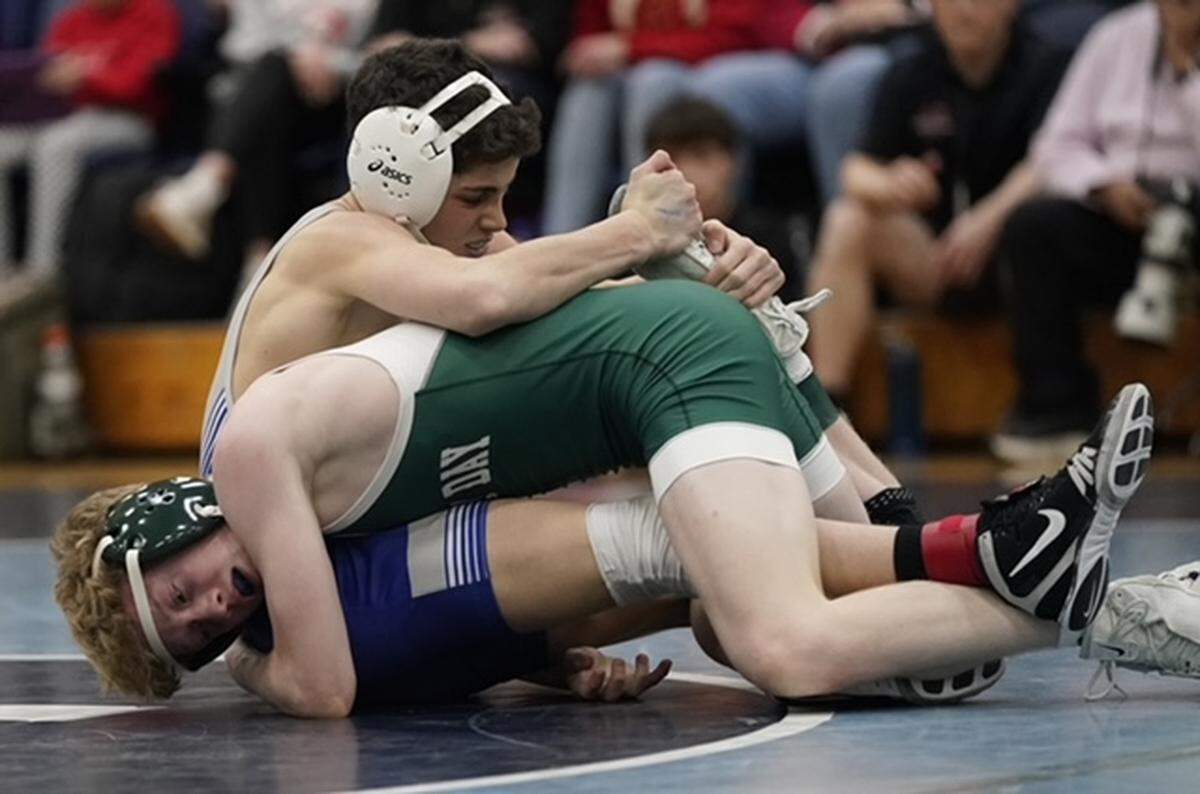 Calvary Day School's Vasili Karabelas, top, gets a leg hold on Charlotte Country Day's Ethan Cole during their 106-pound championship match Saturday at the N.C. Independent Schools Athletic Association's state championships in Charlotte. 
