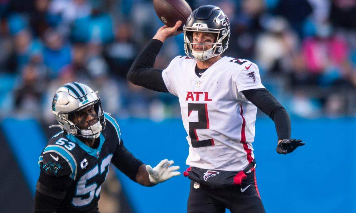 Panthers defense end Brian Burns, left, chases after Falcons quarterback Matt Ryan during the game at Bank of America Stadium on Sunday, December 12, 2021 in Charlotte, NC.