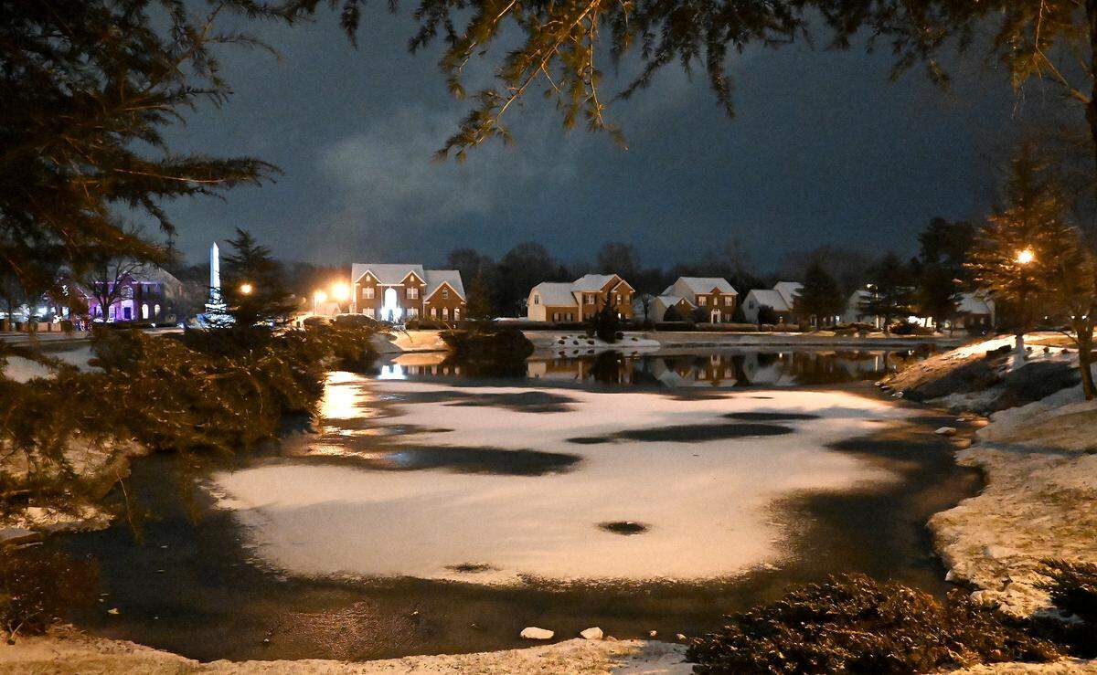 Snow covers the roof tops of homes and a portion of a pond in the Village of Lake Park in Union County on Tuesday, January 21, 2025.