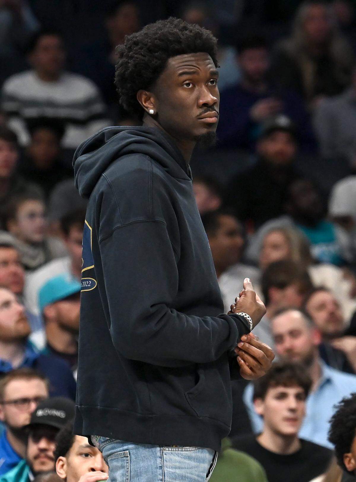 Injured Charlotte Hornets center Mark Williams stands along the team’s baseline during a timeout in first half action against the Milwaukee Bucks at Spectrum Center in Charlotte, NC on Thursday, February 29, 2024.