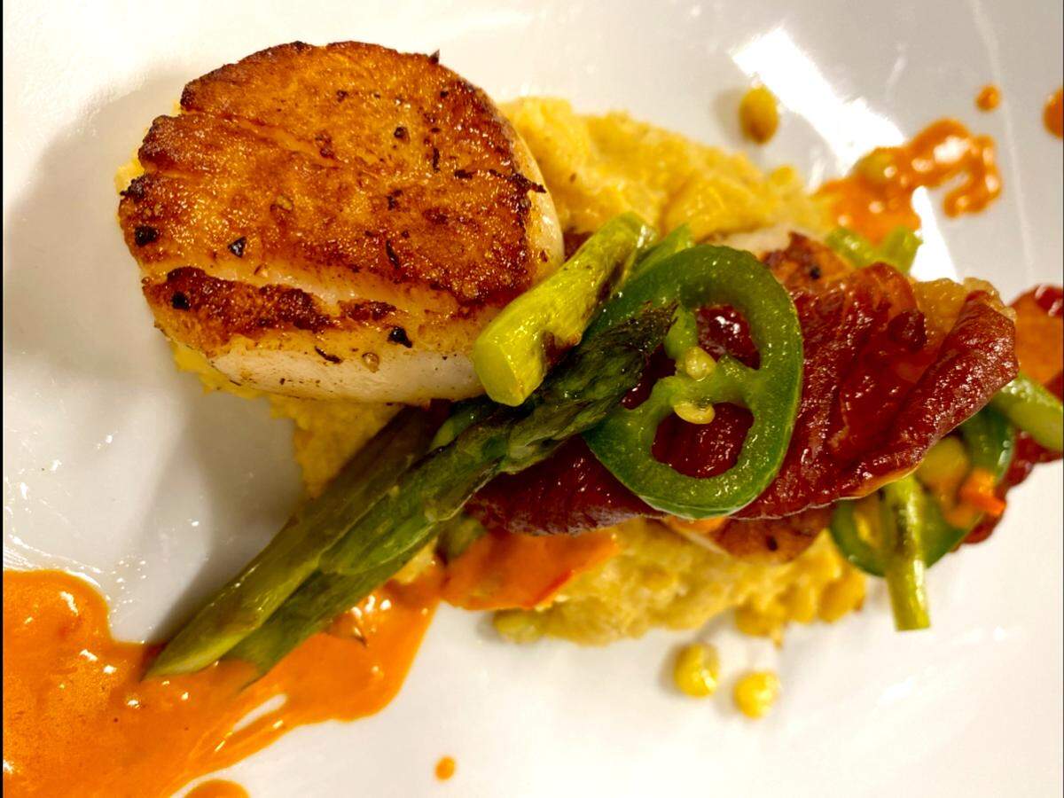 Alchemy is serving Pan-Seared Scallops with corn and jalapeno polenta, asparagus and crispy prosciutto on its Valentine’s Day menu this year.