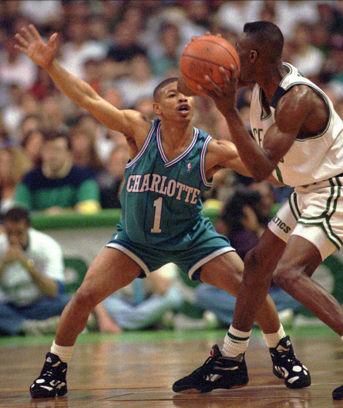 Charlotte's Muggsy Bogues keeps an eye on the ball and Boston's Dee Brown.