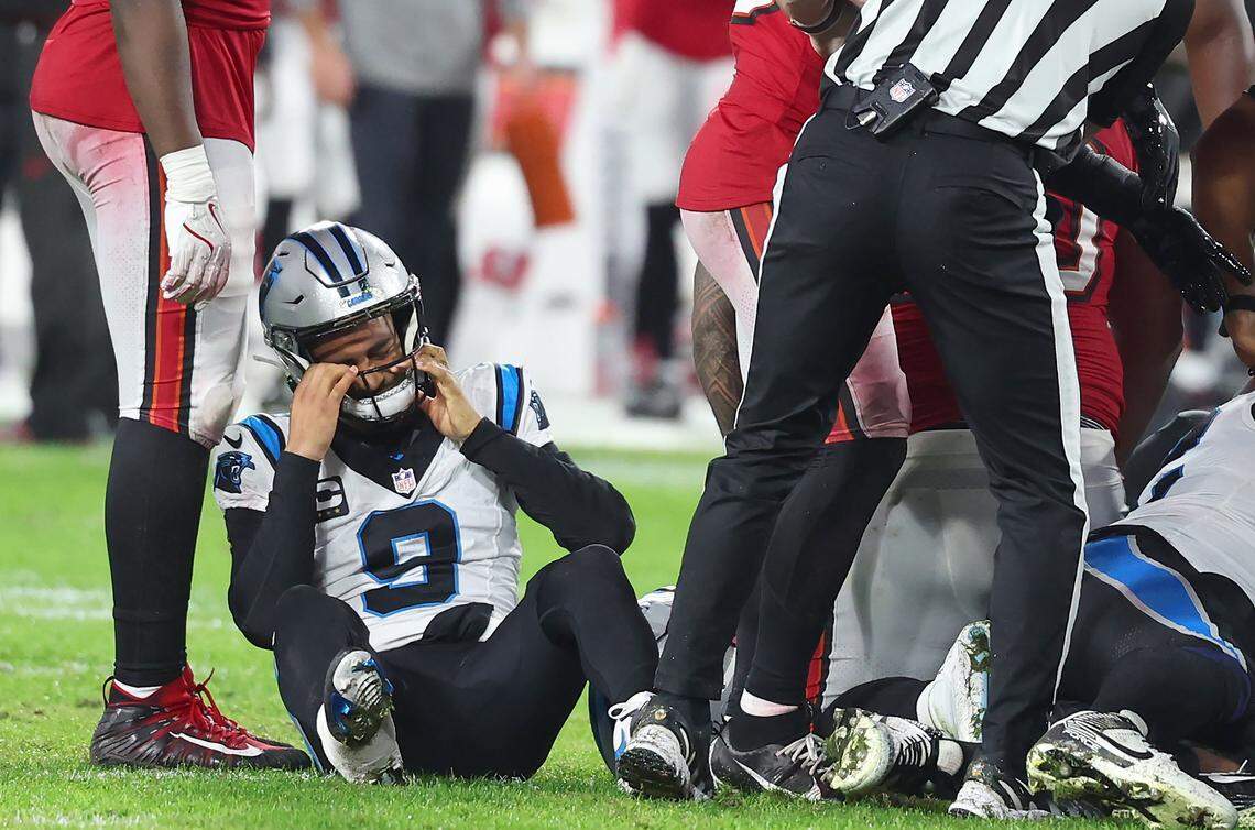 Carolina Panthers quarterback Bryce Young, left, adjusts his helmet after the ball was fumbled with the Tampa Bay Buccaneers recovering during Saturday’s action at Raymond James Stadium in Tampa, Florida. The Buccaneers defeated the Panthers 16-14.