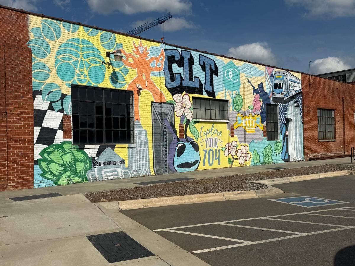 NoDa Brewing, decorated with a CLT mural outside that was done by Southern Tiger Collective, is watching and waiting to see what to do about tariffs on aluminum, stainless steel and other supplies that affect beer production.