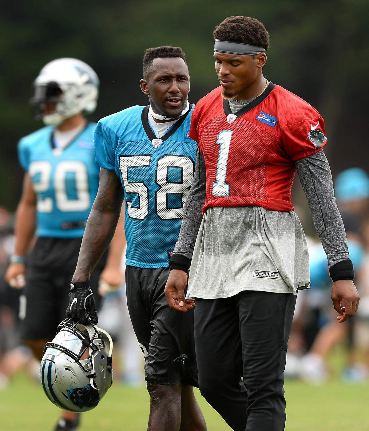 Carolina Panthers linebacker Thomas Davis, left, talks with quarterback Cam Newton, right, during practice on Thursday, August 3, 2017 at Wofford College in Spartanburg, SC.