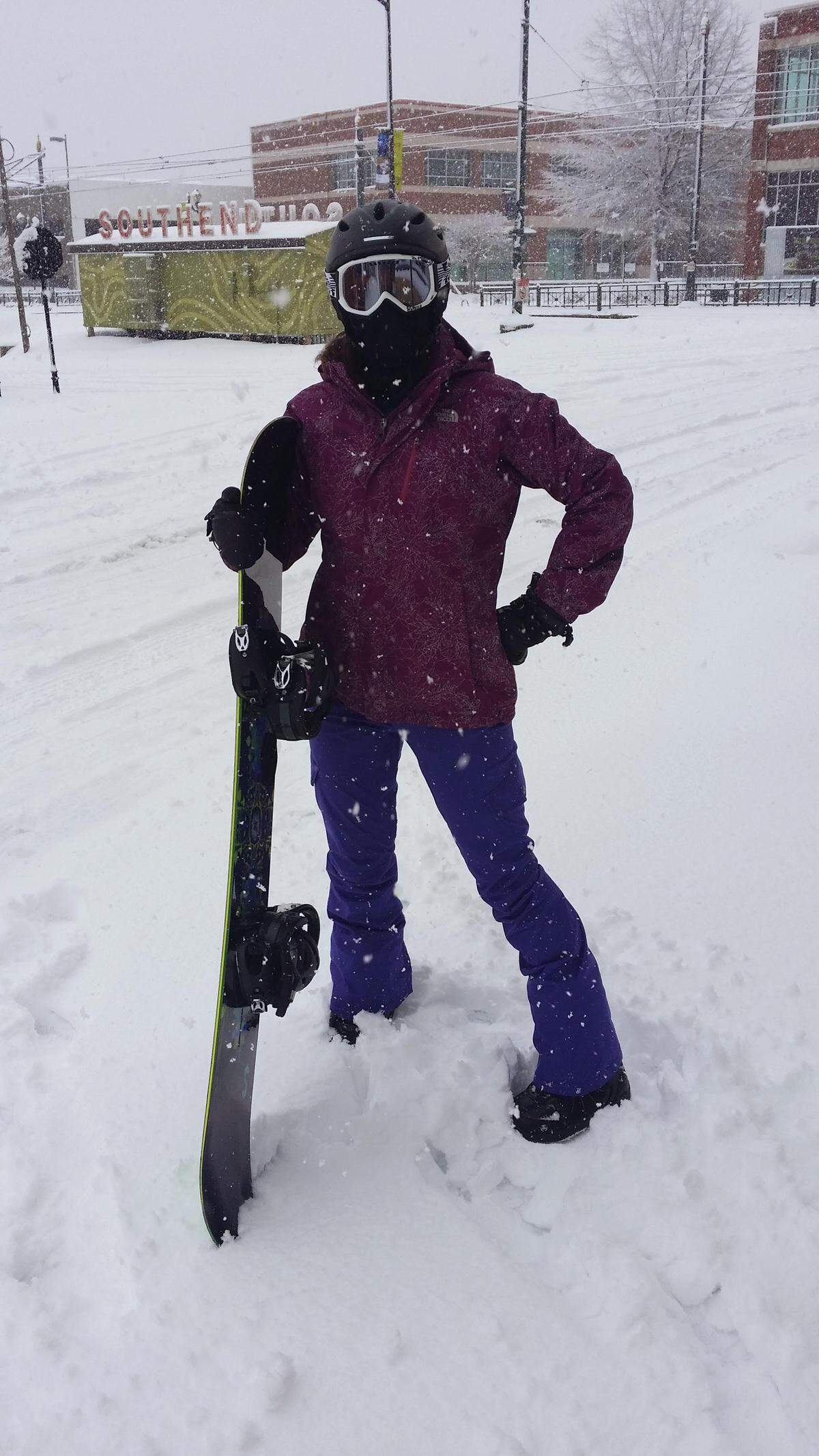 Megan Phillips is photographed in 2014 near Camden and Tremont in South End. “We were supposed to go snowboarding in Colorado but the Charlotte snow canceled our flights,” Sam Phillips said. “We decided to take our snowboards out and ended up on the Charlotte mountains of Latta Park.”