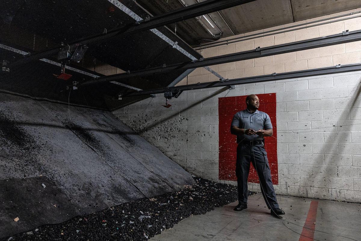 Sgt. C. Anderson holds a broken cable the pulls targets downrange in Firing Range B at the Mecklenburg County Sheriffs Office Training Academy in Charlotte, N.C., on Thursday, June 8, 2023.