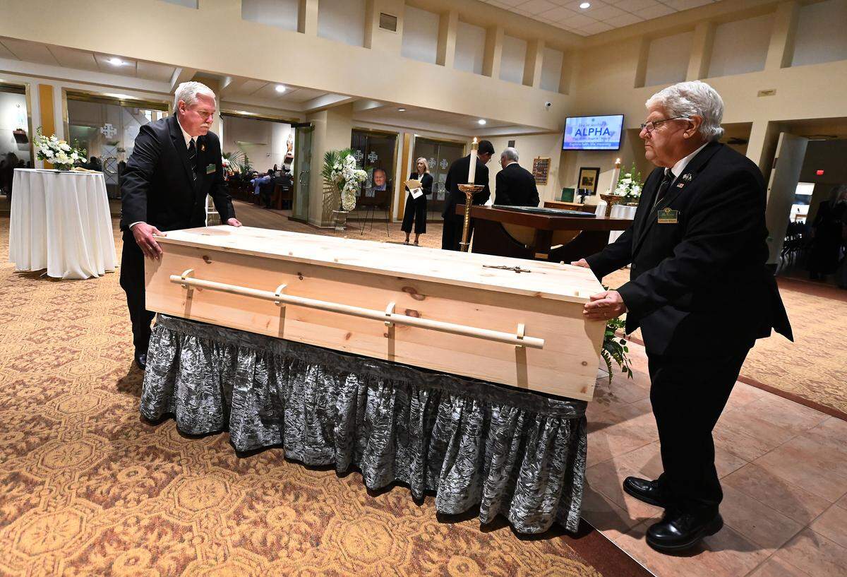 Pallbearers prepare for the funeral of former longtime Charlotte Motor Speedway president H.A. “Humpy” Wheeler, Jr.,on Tuesday, August 26, 2025 at St. Gabriel Catholic Church in Charlotte. 