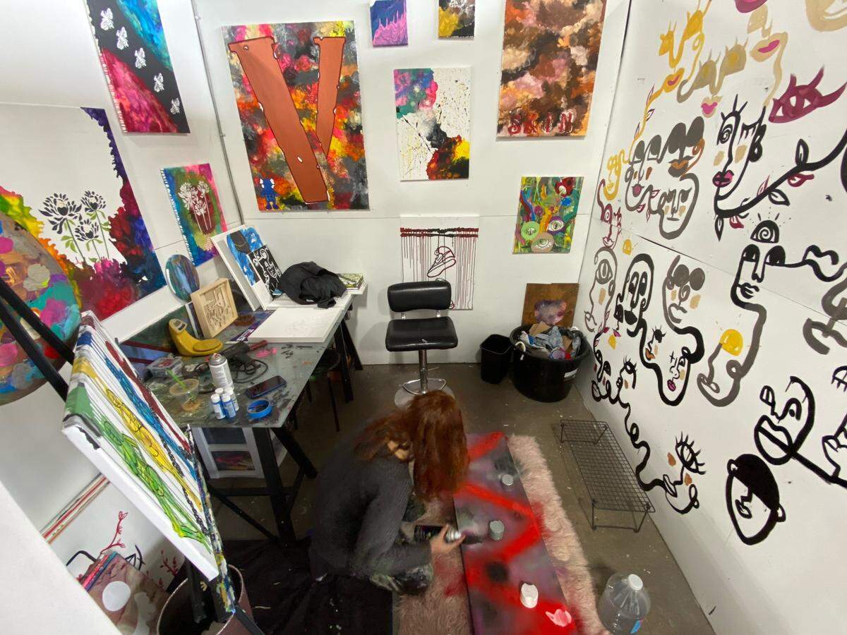Arelys Ripoll works on the floor in her studio at Charlotte Art League. CAL executive director Jim Dukes says Ripoll is an evolving young artist whose current work is “subtle and raw.”