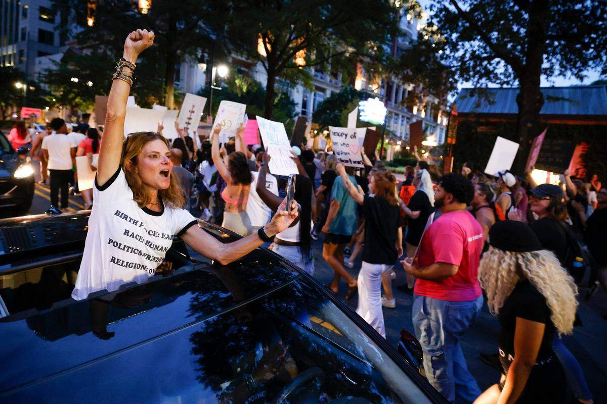 Lisa Landrum, of Charlotte, shows solidarity with abortion rights activists as they march through uptown Charlotte, June 26, 2022. The demonstration was in response to last week’s decision from the U.S. Supreme Court to overturn Roe v. Wade.