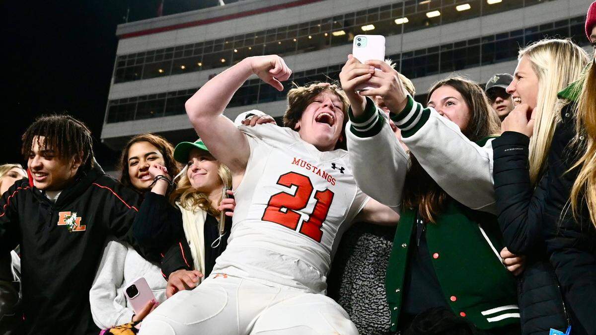 East Lincoln running back Walker Herte, center, celebrates the team’s 30-15 victory over Northern Nash with students at Carter-Finley Stadium in Raleigh, NC on Saturday, December 10, 2022. East Lincoln won the NCHSAA 3A Championship. Jeff Siner/The Charlotte Observer