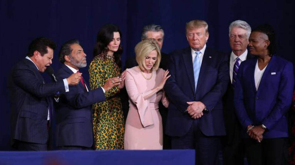 Faith leaders pray over President Trump during a Jan. 3, 2020 “Evangelicals for Trump” campaign event at the King Jesus International Ministry in Miami.