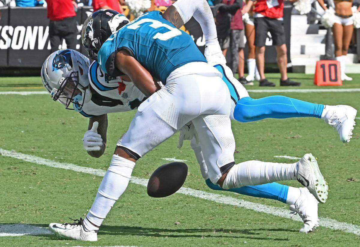 Jacksonville Jaguars cornerback Tyson Campbell, center, stops Carolina Panthers wide receiver Tetairoa McMillan, left, from catching a pass from quarterback Bryce Young in the end zone during action on Sunday, September 7, 2025, at Everbank Stadium in Jacksonville, Florida. The Jaguars defeated the Panthers 26-10.