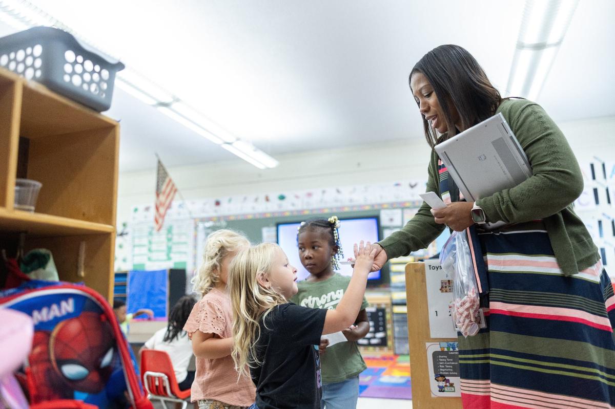Principal Danielle Belton greets students and hands our smarties Paw Creek Elementary in Charlotte, N.C., on Wednesday, September 11, 2024.