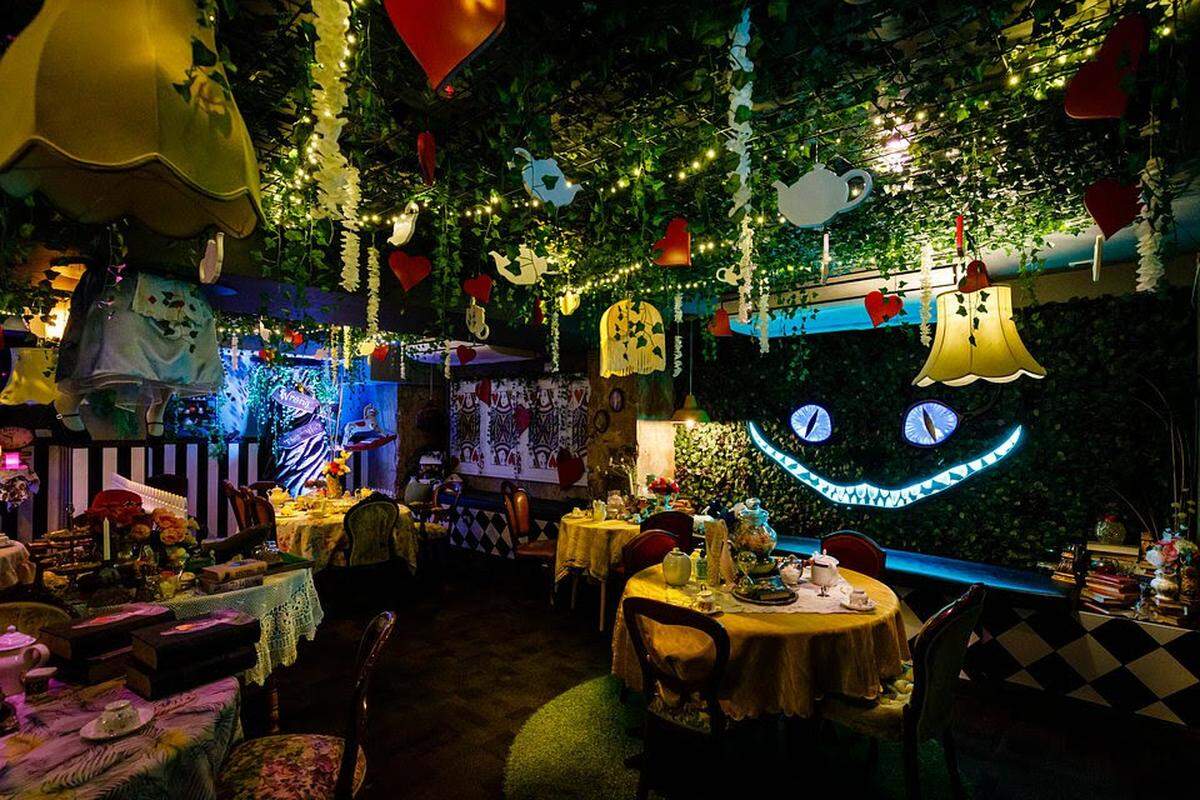 The Cheshire Cat peeks out at guests throughout The Alice: An Immersive Cocktail Experience.