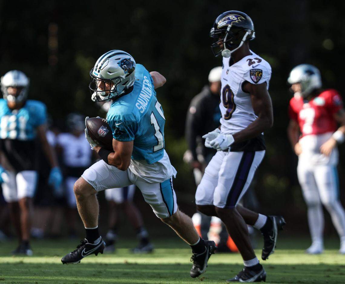 Carolina Panthers wide receiver C.J. Saunders (left) runs past the Baltimore Ravens defensive back Shaun Wade during the two teams’ joint practice in Spartanburg, S.C., on Wednesday. Panthers GM Scott Fitterer said Saunders has been one of the most pleasant surprises of camp.