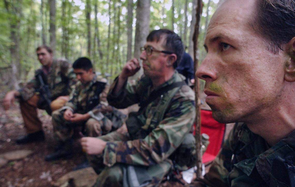 US Army Special Forces Capt. Arthur Garfer (at right) sits as the leader of the guerrilla camp berates him for being late during the Robin Sage training exercise in the Uwharrie National Forest under the cover of darkness as they participate in the Robin Sage training exercise. The training exercise for Special Forces applicants is the largest of it’s kind in the world and puts the men in real life scenarios dealing with problem solving not just fighting.