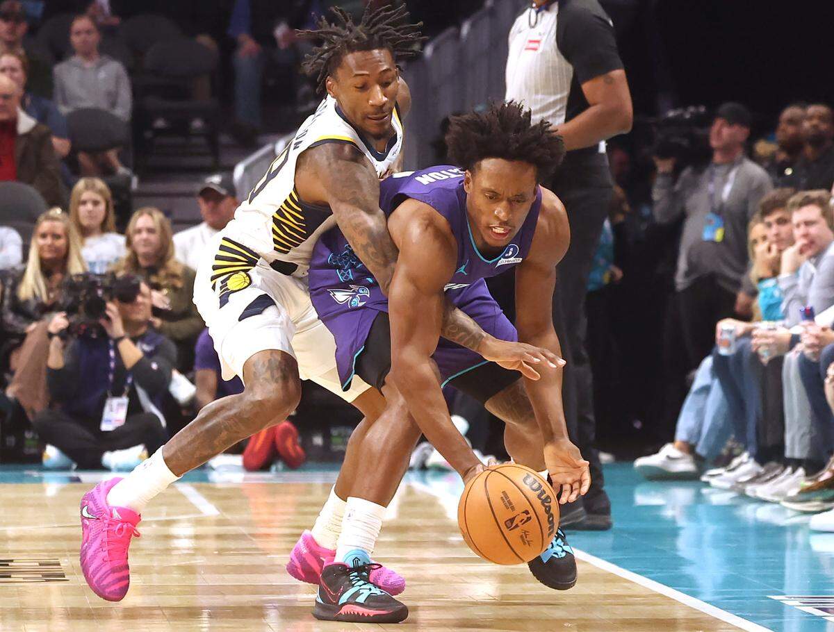Charlotte Hornets guard Collin Sexton, right, fights to maintain control of the ball as Indiana Pacers guard Quenton Jackson, left, applies defensive pressure during action at Spectrum Center in Charlotte, NC on Thursday, January 8, 2026. 