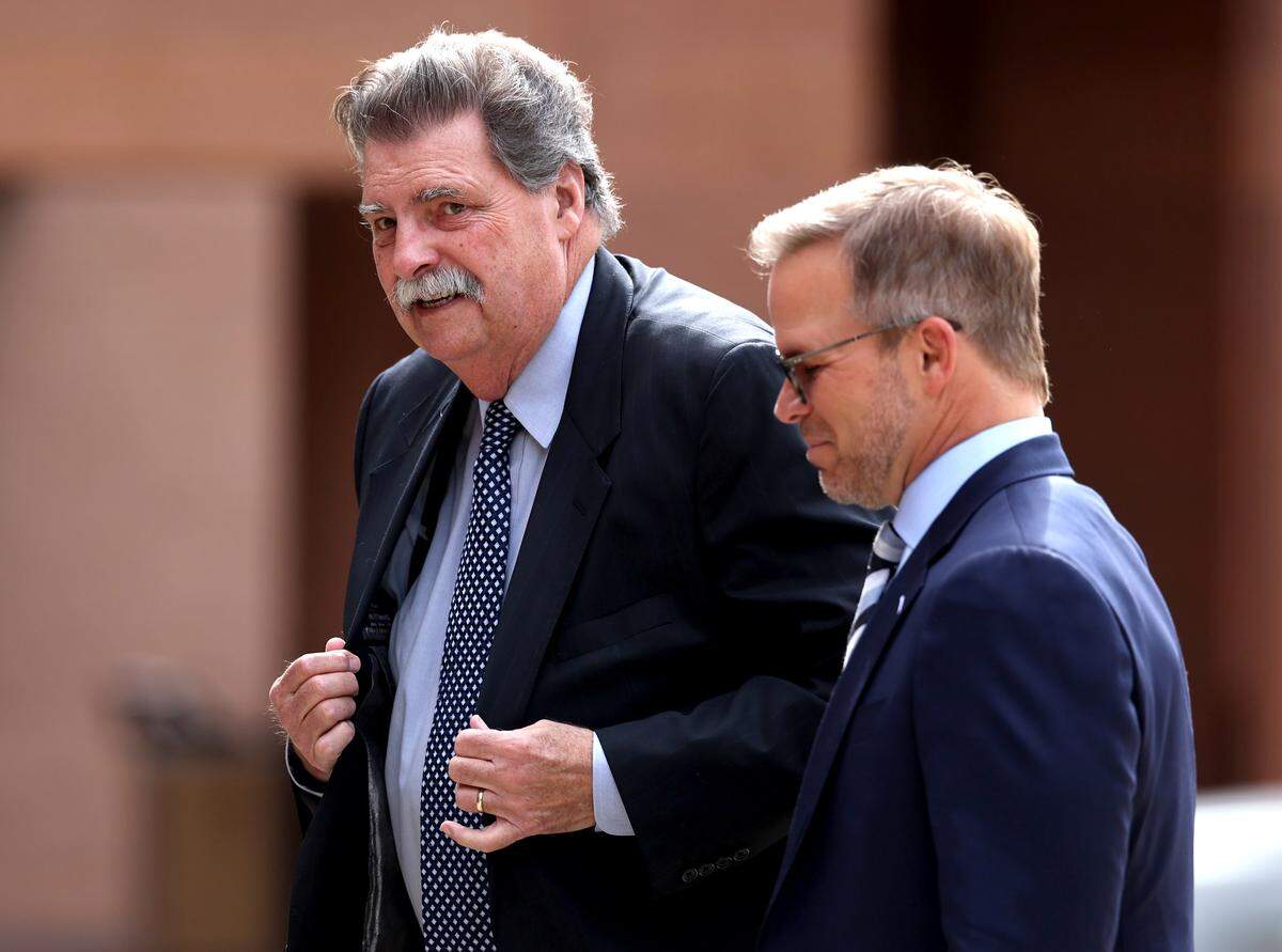 NASCAR vice chairman Mike Helton, left, arrives for the funeral of former longtime Charlotte Motor Speedway president H.A. “Humpy” Wheeler, Jr., with Marcus Smith, right, CEO of Speedway Motorsports on Tuesday, August 26, 2025 at St. Gabriel Catholic Church in Charlotte.