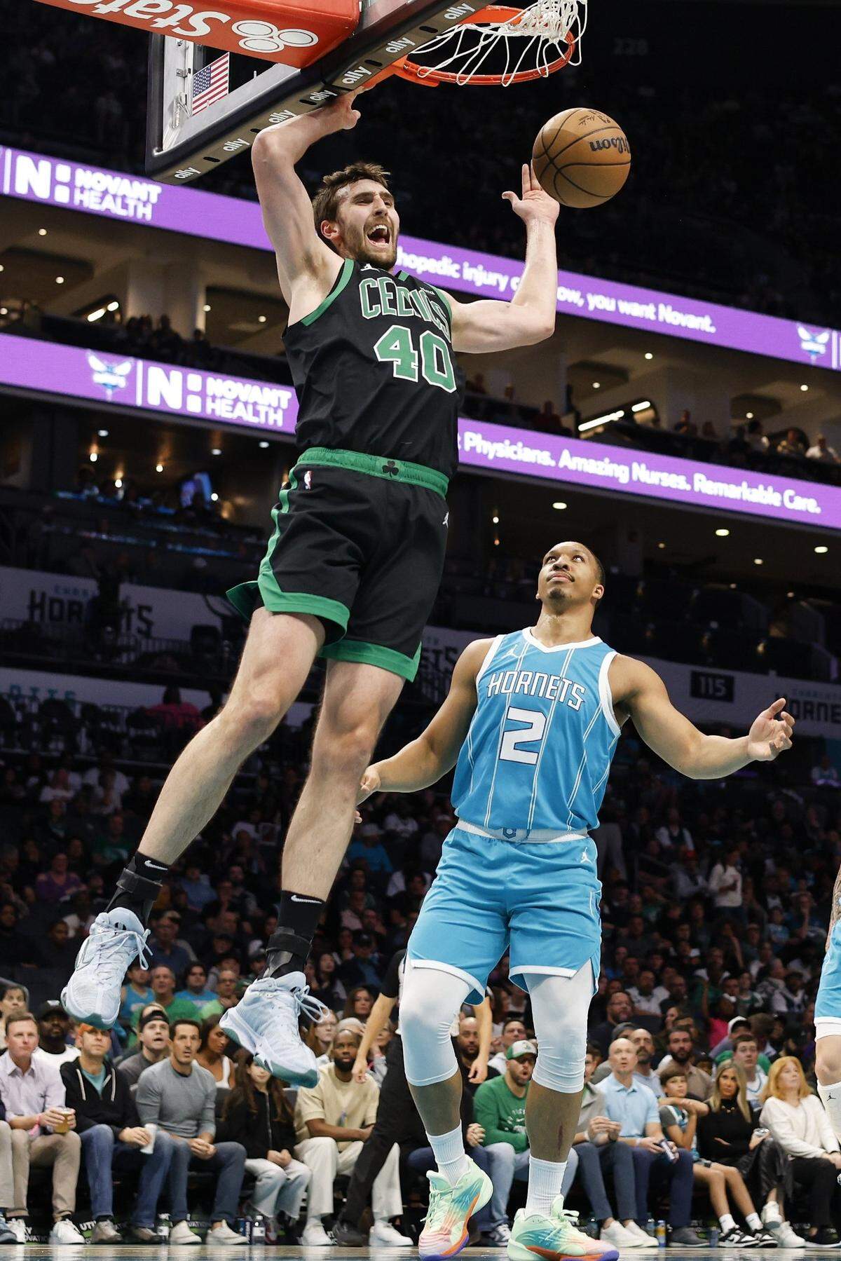 Boston Celtics center Luke Kornet (40) yells as he dunks against Charlotte Hornets forward Grant Williams (2) during the first quarter at Spectrum Center.