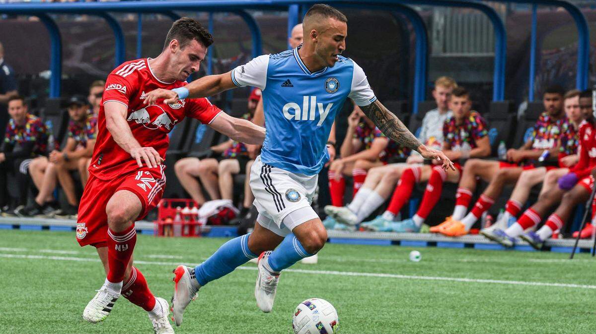 Charlotte FCs Andre Shinyashiki, right, dribbles the ball away from New York Red Bulls Dylan Nealis during the game at Bank of America Stadium on Saturday, June 11, 2022 in Charlotte, NC.