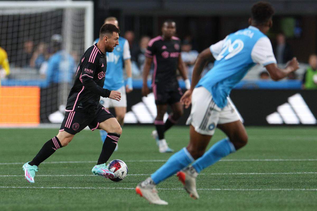 Inter Miami’s Lionel Messi, left, dribbles the ball during the match against Charlotte FC at Bank of America Stadium on Saturday, October 21, 2023 in Charlotte, NC.