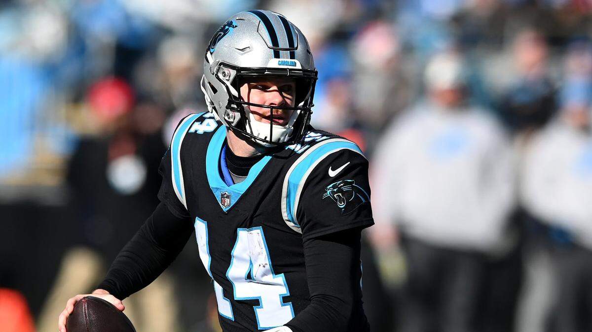 Carolina Panthers quarterback Sam Darnold rolls out of the pocket looking to pass during second quarter action against the Detroit Lions at Bank of America Stadium on Saturday, December 24, 2022 in Charlotte, NC.