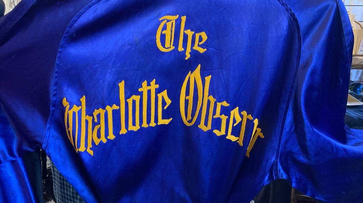 A little internet sleuthing helped put the pieces of the puzzle together on why The Charlotte Observer was on the back of a satin robe.