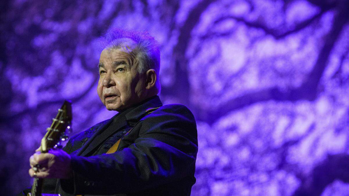 FILE -- John Prine performs at the historic Ryman Auditorium in Nashville, Tenn., in 2018. Prine, the raspy-voiced country-folk singer whose ingenious lyrics to songs by turns poignant, angry and comic made him a favorite of Bob Dylan, Kris Kristofferson and others, died Tuesday, April 7, 2020, at Vanderbilt University Medical Center in Nashville, Tenn. He was 73. (William DeShazer/The New York Times)