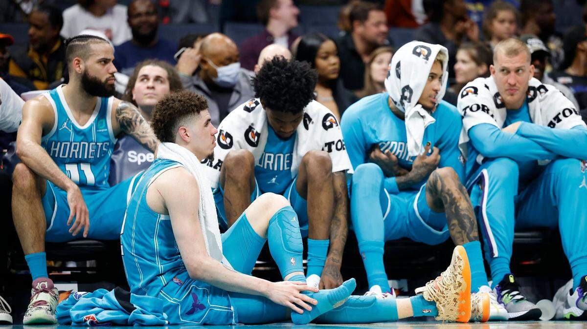 Charlotte Hornets guard LaMelo Ball (2) stretches near the bench late in the fourth quarter during a game against the New York Knicks at Spectrum Center in Charlotte, N.C., Wednesday, March 23, 2022. New York defeated Charlotte 121-106.