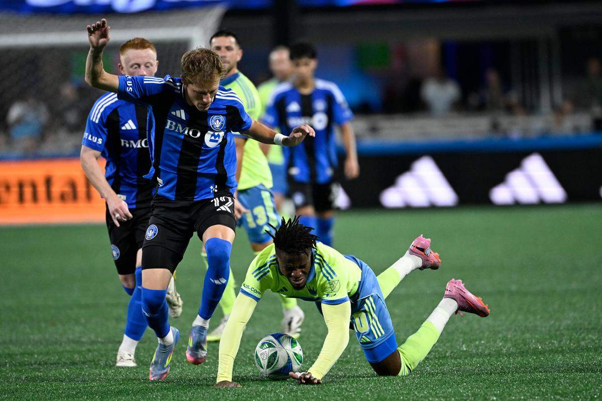 Sep 27, 2025; Charlotte, North Carolina, USA;  CF Montréal midfielder Nathan-Dylan Saliba (19) and Charlotte FC forward Wilfried Zaha (10) fight for the ball in the first half at Bank of America Stadium. Mandatory Credit: Bob Donnan-Imagn Images