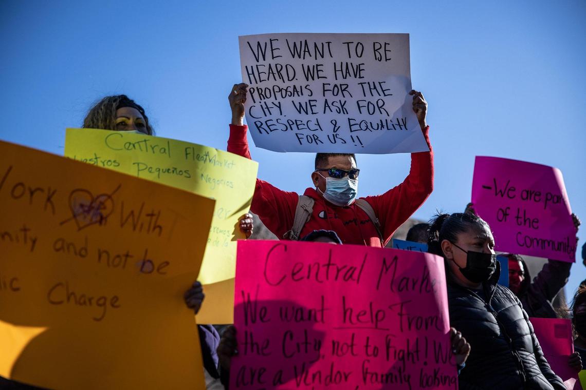 Vendors of the Central Flea Market hold signs during a press conference held outside the Charlotte-Mecklenburg Government Center in uptown Monday afternoon. On Feb. 11, city of Charlotte staff and CMPD officers went to the site of the open-air market at the former Eastland Mall site and told the vendors they could no longer be on the site. The flea market has been operating there for years, but there’s been some uncertainty to its future due to a recent rezoning and a proposed mixed-use project.