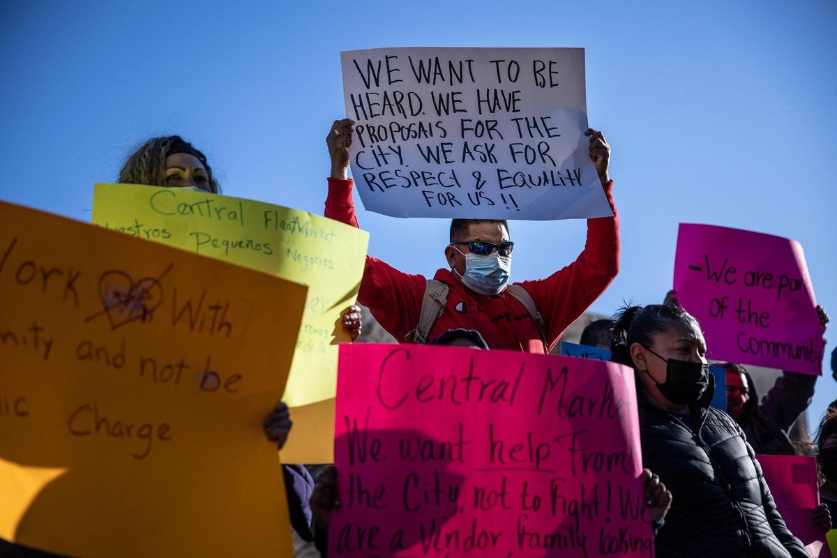 Vendors of the Central Flea Market hold signs during a press conference held outside the Charlotte-Mecklenburg Government Center in uptown Monday afternoon. On Feb. 11, city of Charlotte staff and CMPD officers went to the site of the open-air market at the former Eastland Mall site and told the vendors they could no longer be on the site. The flea market has been operating there for years, but there’s been some uncertainty to its future due to a recent rezoning and a proposed mixed-use project. 