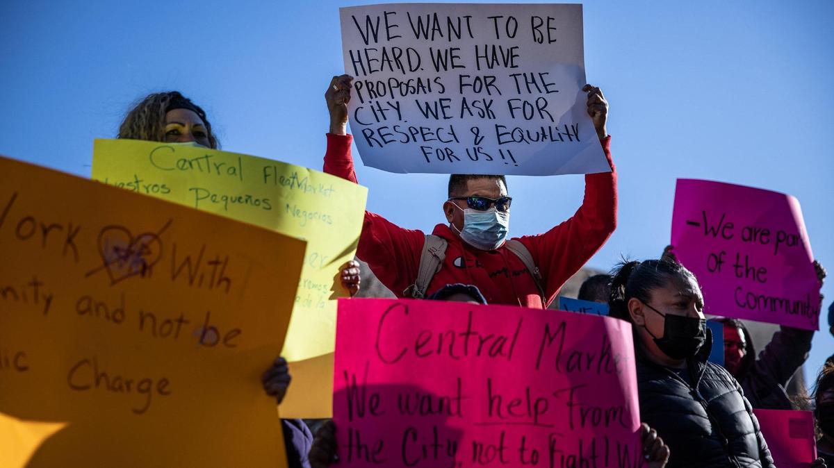 Vendors of the Central Flea Market hold signs during a press conference held outside the Charlotte-Mecklenburg Government Center in uptown Monday afternoon. On Feb. 11, city of Charlotte staff and CMPD officers went to the site of the open-air market at the former Eastland Mall site and told the vendors they could no longer be on the site. The flea market has been operating there for years, but there’s been some uncertainty to its future due to a recent rezoning and a proposed mixed-use project. 