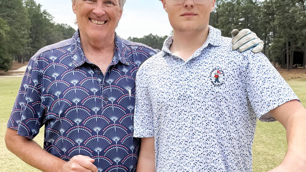 John Dunlap and his son Jake Dunlap pose at Pinehurst No.2 10th tee.