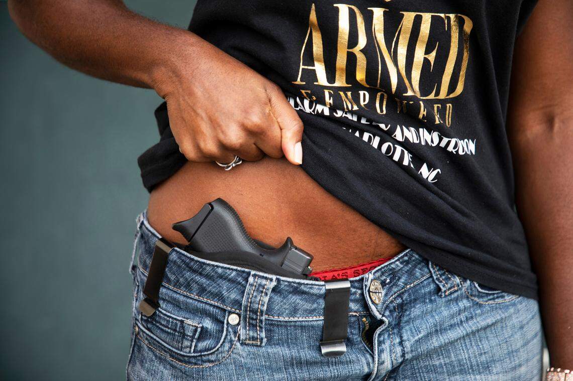 Kisha Kincaid shows her gun for the camera at a gun range in Concord, NC Wednesday August 17, 2022.