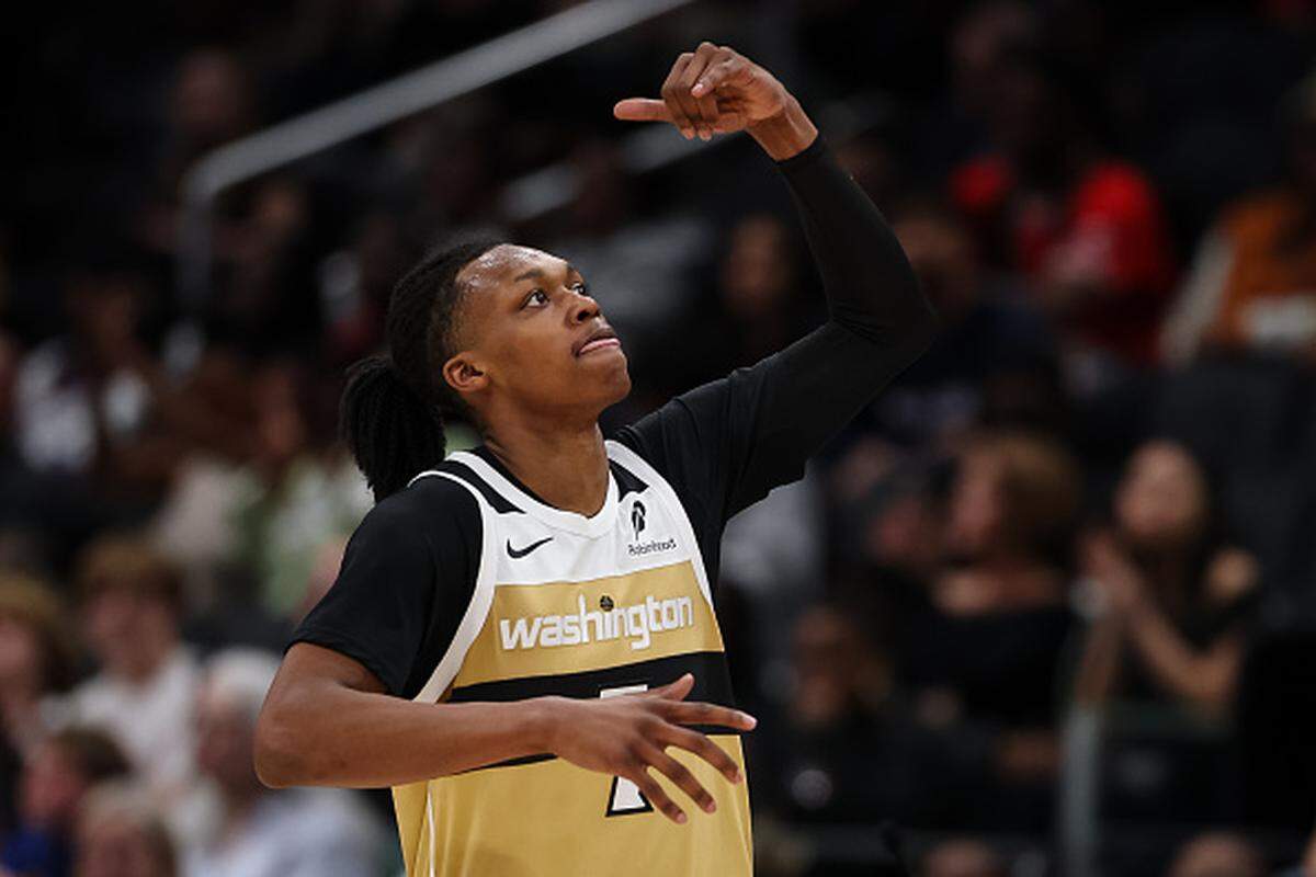Bub Carrington of the Washington Wizards reacts after making a three-point basket against the Miami Heat during the first half at Capital One Arena.