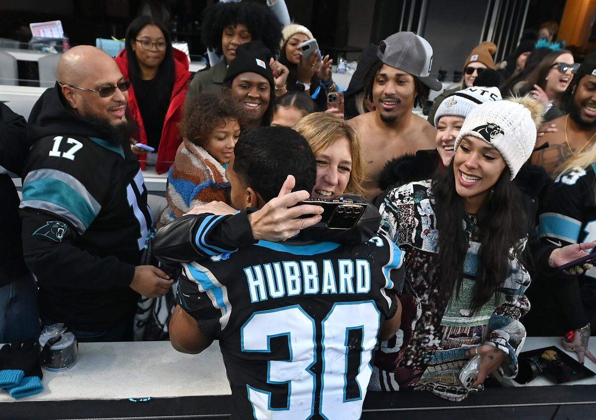 Carolina Panthers running back Chuba Hubbard is congratulated by fans following his game winning rushing touchdown in overtime to defeat the Arizona Cardinals at Bank of America Stadium in Charlotte on Sunday, December 22, 2024. The Panthers defeated the Cardinals in overtime 36-30.