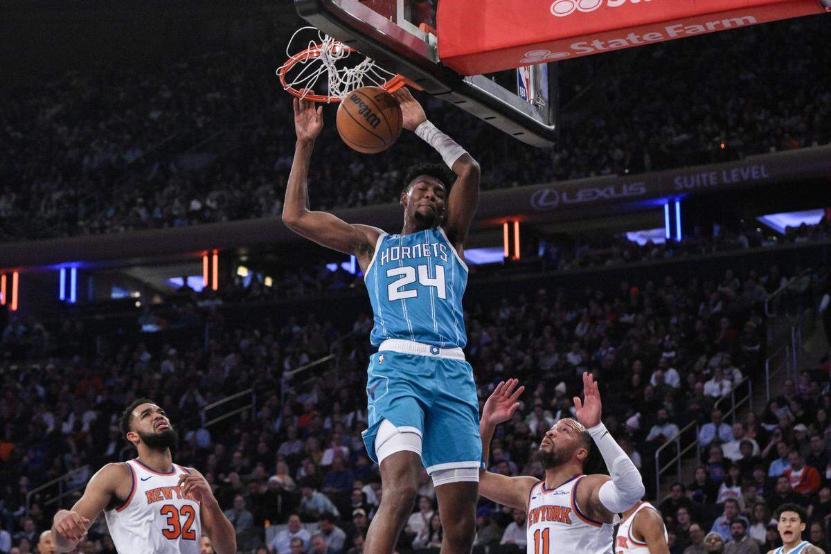 Charlotte Hornets forward Brandon Miller (24) dunks the ball as New York Knicks guard Jalen Brunson (11) defends during the first half at Madison Square Garden. 
