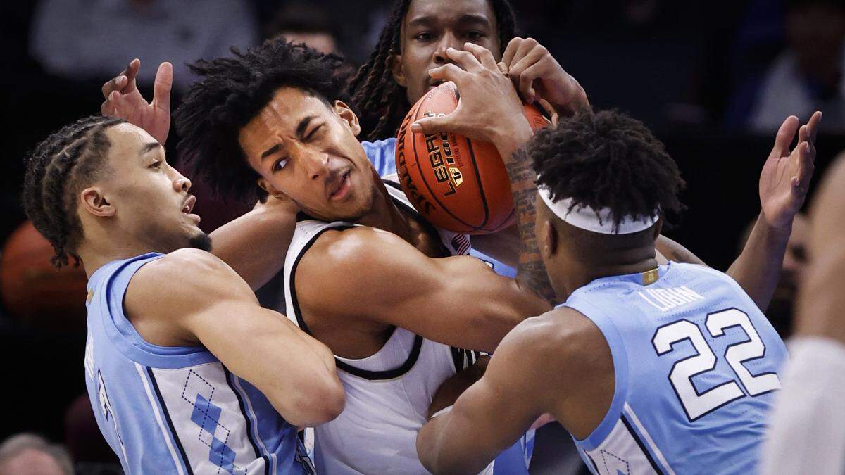 North Carolina’s Seth Trimble (7) and Ven-Allen Lubin (22) swarm Wake Forest’s Juke Harris (2), causing him to turn the ball over during the second half of UNC’s 68-59 victory over Wake Forest in the quarterfinals of the 2025 ACC Men’s Basketball Tournament at the Spectrum Center in Charlotte, N.C., Thursday, March 13, 2025.